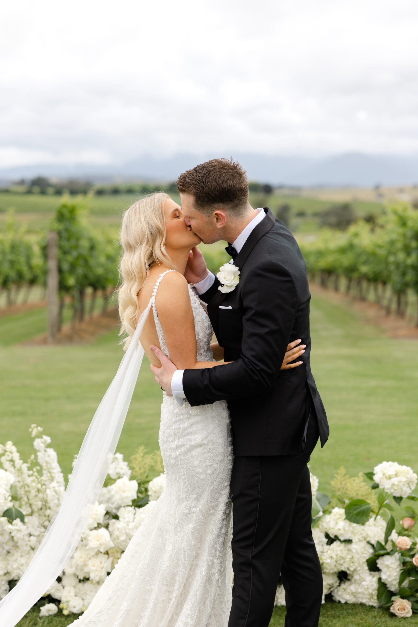 Bride and couple kissing at ceremony at Acacia Ridge in the Yarra Valley